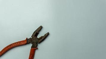 old and rusty pliers isolated on white photo