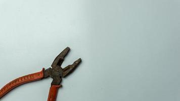 old and rusty pliers isolated on white photo