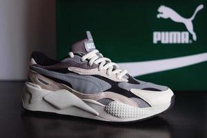 Minsk, Belarus - March 4, 2020 Puma RS-X3 Puzzle sneakers, running shoes with Puma logo at the box photo