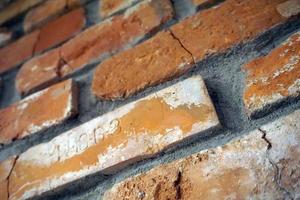 Vintage, Cracked Bricks with Letters on a Wall photo