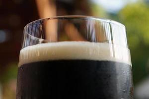 Glass of Dark Beer, Defocused Background photo