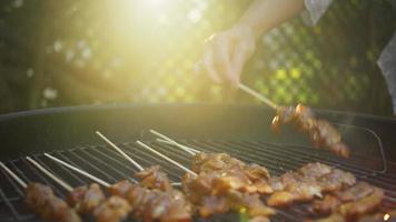 Placing Raw Chiken Skewers on a Hot Grill