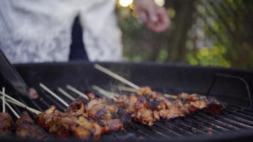 Turning Chicken Skewers on a Grill video
