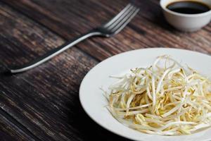 Bean sprouts of mung, maash. Traditional vegan dish in east Asia. Healthy diet food. photo