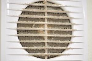 Dirty air ventilation grill of HVAC with clogged filter. photo