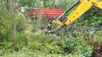 Up close view of excavator digging into the ground video