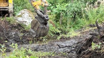 Up close view of excavator digging into the ground video