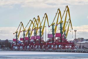 Harbor cranes, container ship terminal, cargo container yard photo