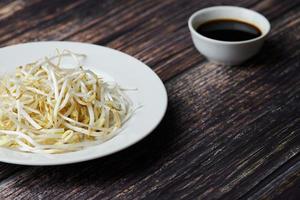 Mung bean sprouts in plate. Raw organic healthy food. Traditional vegetable dish in east Asia. photo