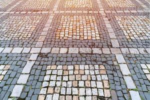 Old paving stones pattern. Texture of ancient german cobblestone in city downtown. Little granite tiles. Antique gray pavements. photo