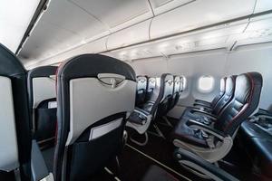 Airplane seats and windows. Economy class comfortable seats without passengers. New low-cost carrier airline photo