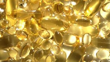 vitaminas d, cápsulas omega 3, macro video