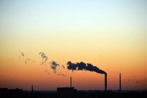 Smoke Coming From Factory Chimney at Sunset photo