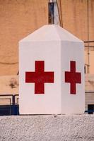 Red cross on concrete detail photo