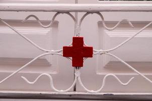 Red cross on metal detail photo