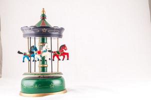 Vintage metal carousel toy on white background photo