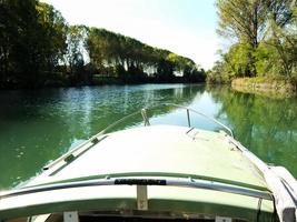 Boat and trees by the river photo