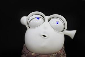 Funny robot face on a black background. photo