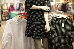 Department for the sale of women's clothing. Part of a manikin in a polka dot dress. photo