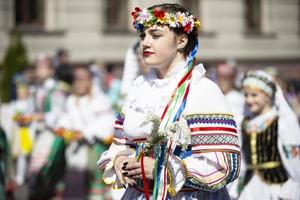 Belarus, Gomil 09.05.2021. Holiday in the city. A number of girls in national costumes with a wreath on their heads. photo