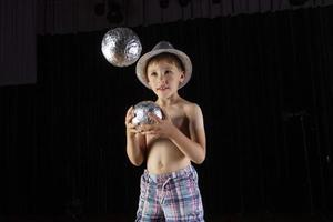 Little boy learns to juggle. Child of the circus. photo