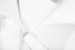 White sheets of office paper are twisted and scattered. Paper white abstract background. photo