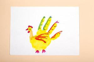 Children's drawing. Application of children's creativity. Kindergarten and craft school. The child drew a chicken with his fingers.