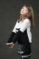 Portrait of a beautiful girl posing on a gray background. photo