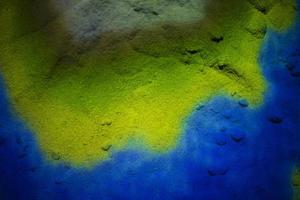 Background of multi-colored scattered sand.The colors of the Ukrainian flag are blue and yellow. photo