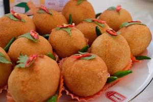 Kroket kentang is a traditional snack from Indonesia. served in wooden plate with green chilli. Delicious Indonesian Traditional Kroket Kentang with chilli photo