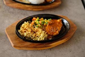 Close-up of a bowl of soba noodles with sliced roast beef steak. Asian cuisine photo