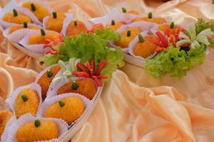 Kroket kentang is a traditional snack from Indonesia. served in wooden plate with green chilli. Delicious Indonesian Traditional Kroket Kentang with chilli photo