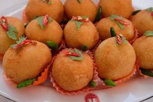 Kroket kentang is a traditional snack from Indonesia. served in wooden plate with green chilli. Delicious Indonesian Traditional Kroket Kentang with chilli photo