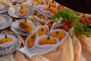 Kroket kentang is a traditional snack from Indonesia. served in wooden plate with green chilli. Delicious Indonesian Traditional Kroket Kentang with chilli photo