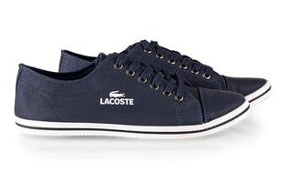 KAMCHATKA, RUSSIA - JANUARY 16, 2023-  The lacoste blue comfortable shoes for man isolated on white background. photo