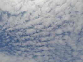 hermosas nubes blancas sobre fondo de cielo azul profundo. grandes nubes esponjosas suaves y brillantes cubren todo el cielo azul. foto