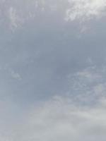 Beautiful white clouds on deep blue sky background. Large bright soft fluffy clouds are cover the entire blue sky. photo