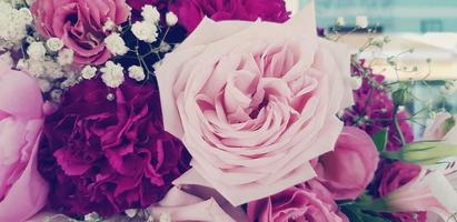 Beautiful pink rose with another flower in blue vintage filter color style for background. Beauty of Nature, Natural wallpaper, Celebration, Gift and Valentine day concept photo