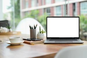 Laptop blank screen on wood table with coffee cafe background, mockup, template for your text, photo