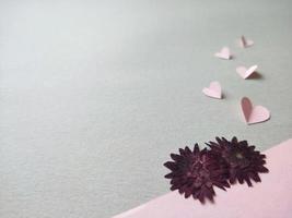 Pink dried flowers and paper hearts photo