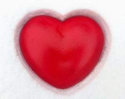 Red heart on snow photo