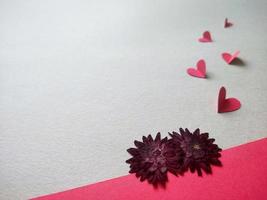 Red dried flowers and paper hearts photo