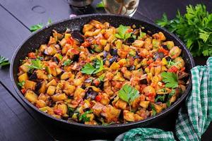 Ratatouille. Vegetarian stew  eggplants, bell peppers, onions, garlic and tomatoes with herbs.  Traditional french food. photo