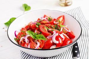 Tomato salad with basil and red onions. Homemade food.  Concept healthy meal. Vegan cuisine. photo