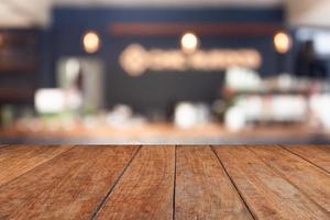 Perspective brown wood on blur cafe with light bulb background photo