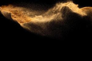 Dry river sand explosion.Brown color sand splash against black background. photo