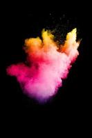 Pink yellow powder splash on white background,Freeze motion of color powder exploding. photo