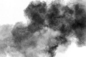 Black powder explosion against white background.Charcoal dust particles cloud. photo