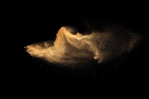 Dry river sand explosion.Brown color sand splash against black background. photo