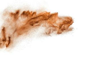 Brown colored sand splash.Dry river sand explosion isolated on white background. photo